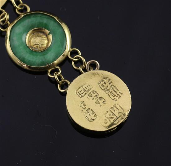 A Chinese gold and jadeite disc link bracelet, 6.75in.